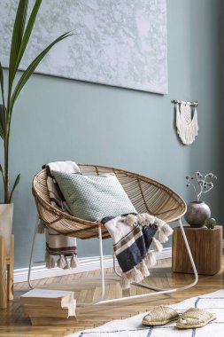 Şık rattan koltuk, ekose, yastık makrame, ahşap küp, çiçek, bitki ve zarif aksesuarları ile modern evde oturma odası iç tasarımı. Tasarım ev dekorasyonu. Şablon. Soyut resimler