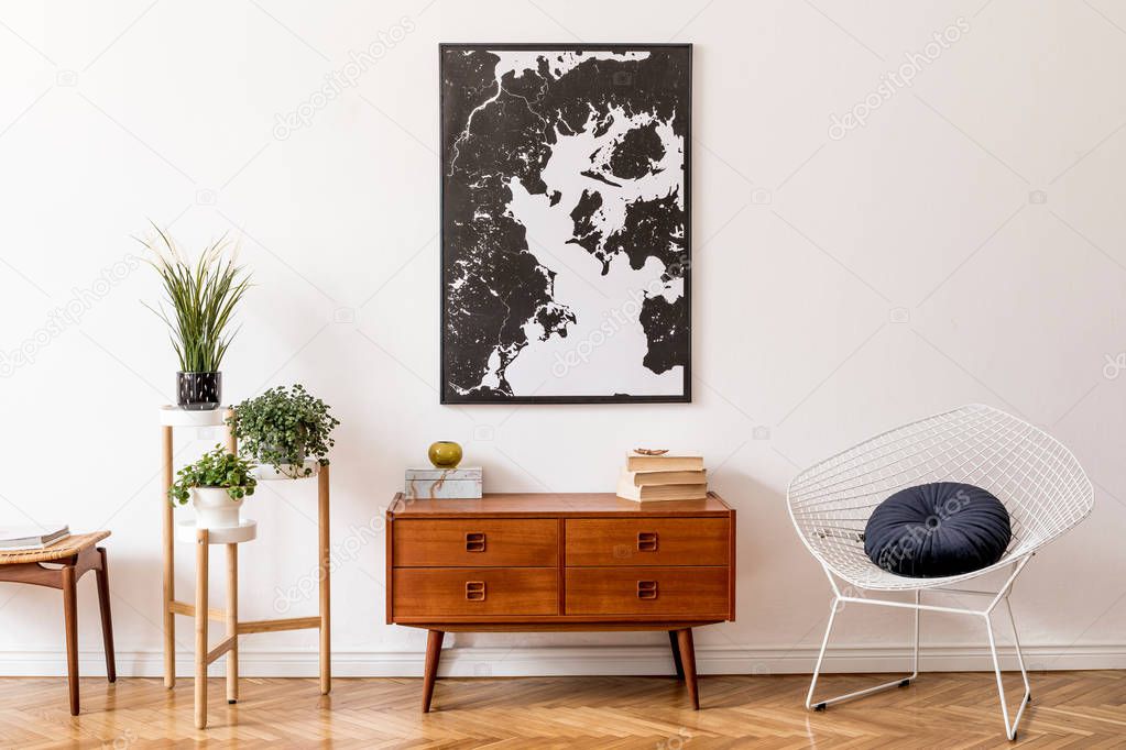 Stylish and modern interior of living room with elegant accessories. Design home decor. Map on wall and wooden commode