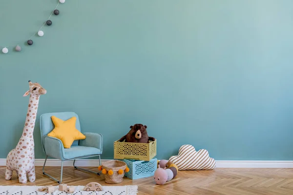 Stylish scandinavian kid room with toys, teddy bear, plush animal toys, mint armchair, umbrella, cotton balls. Modern interior with eucalyptus background walls, Design interior of childroom. Template