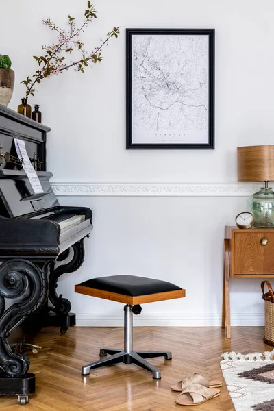 Stylish composition at living room interior with black piano, design stool, black mock up poster map, spring flowers, lamp, furniture and elegant presonal accessories in modern home decor.