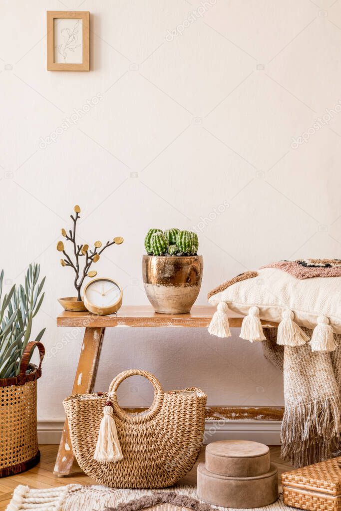 Stylish composition of living room interior with mock up frame, wooden bench, pillow, plaid, rattan basket, plants, decortaion, copy space and elegant personal accessories in modern home decor.