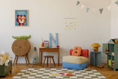 Yaratıcı ve rahat çocuk bölgesi çizgili puf, açık mavi gitar, büyük boy harfler ve klasik ahşap masa. Poster çerçevesini düzenle.