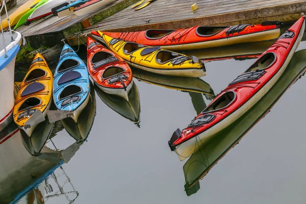 colorful kayaks standing on the pier with calm waters on Ketchikan, Alaska