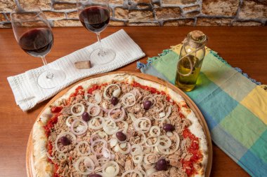 Pizza ton balığı, soğan, domates ve ahşap masada siyah zeytin. Geleneksel Brezilya Pizzası.