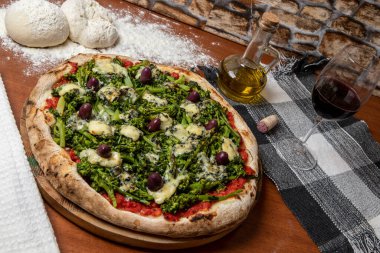 Brokoli, gorgonzola peyniri, siyah zeytin, sarımsak ve domates soslu pizza.