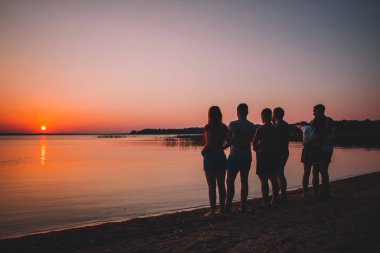 Grup günbatımı kumsalda eğleniyor güzel insan