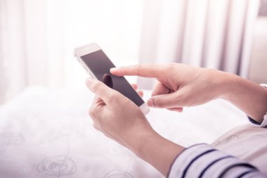 eller kadın tutarak ve smartphone kullanarak