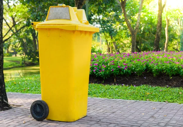 yellow garbage bins in the garden park