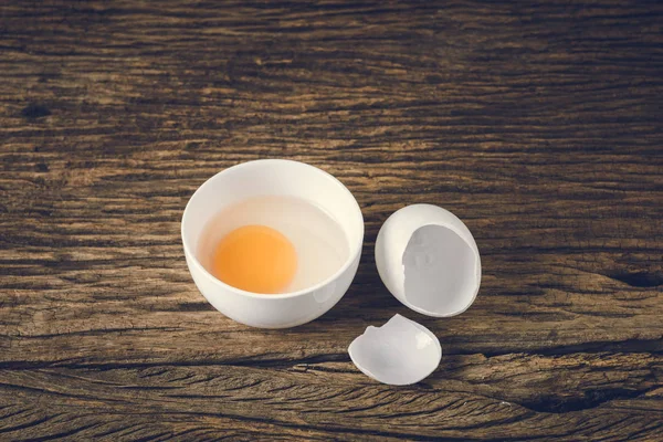 still life of duck egg and Egg yolks in a bowl on grunge wooden background