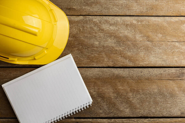 safety register with helmet on wooden background. Retro style Color