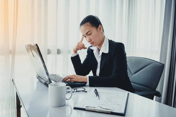 Businesswoman using computer in the office. Stress in the office