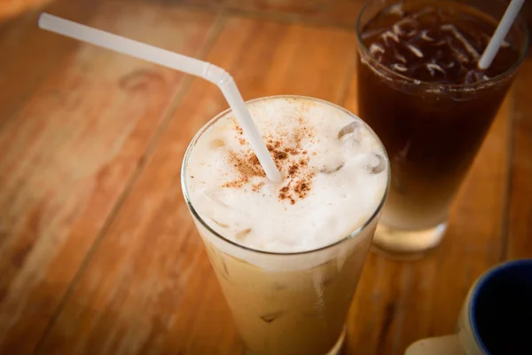 Glass Of Cold Coffee On Wooden table. Latte, Cappuccino cold and syrup cup
