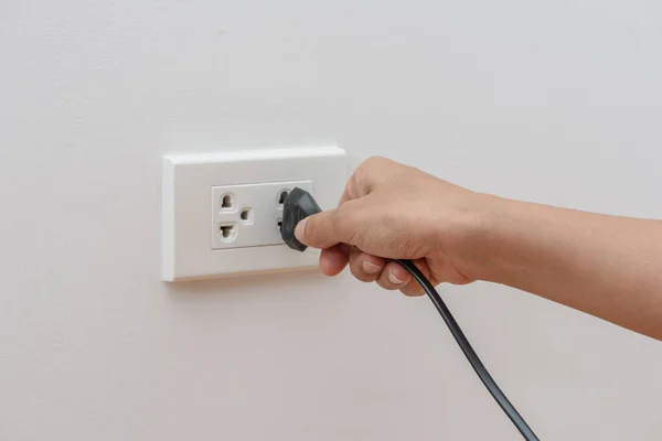 Female Hand Trying Plugging Appliance Electrical Outlet Wall Power Saving Stock Picture