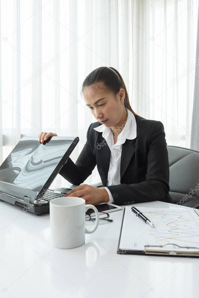 Business woman using laptop computer in office