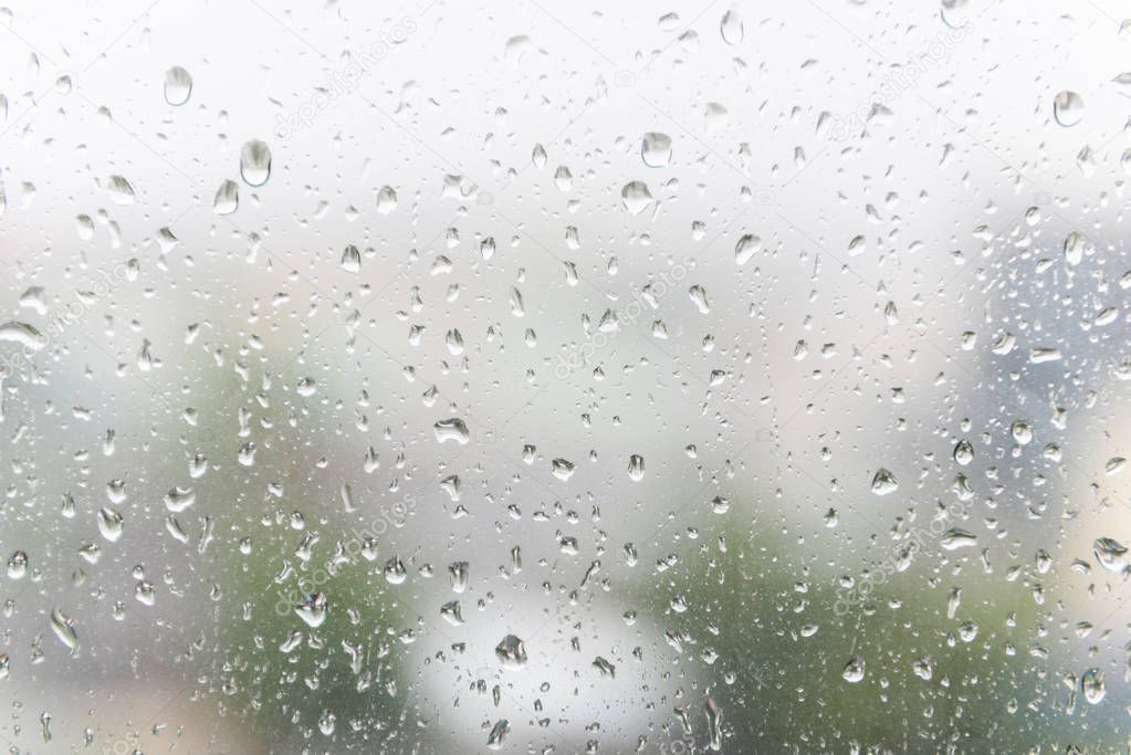 Rain drops on the window glass with dark  background.