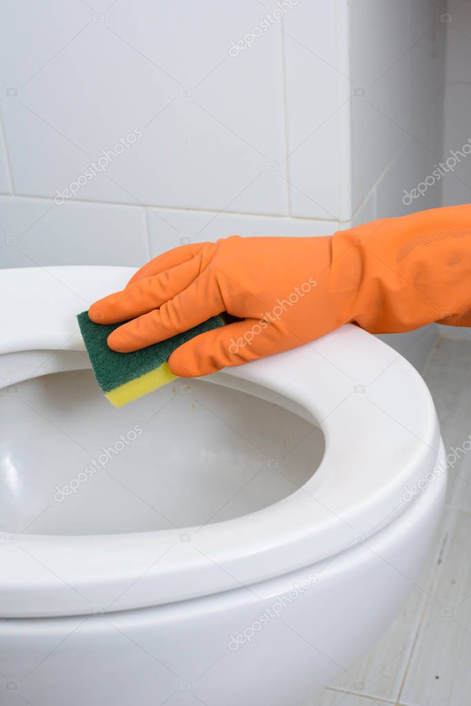 Hands in Orange gloves cleaning WC, Toilet, lavatory