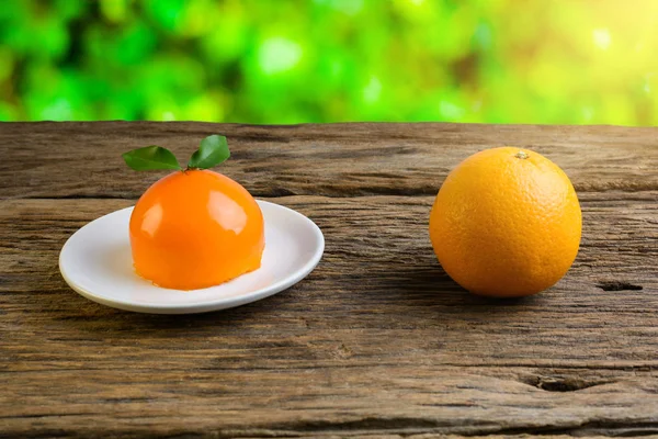 Orange cake on grunge wooden table — Stock Photo, Image