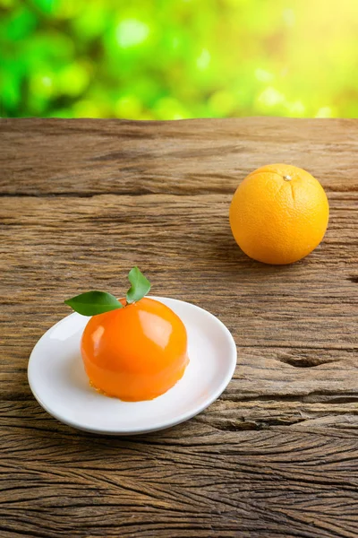 Orange cake on grunge wooden table — Stock Photo, Image