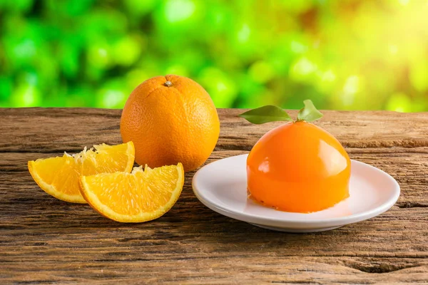 Orange cake on grunge wooden table — Stock Photo, Image