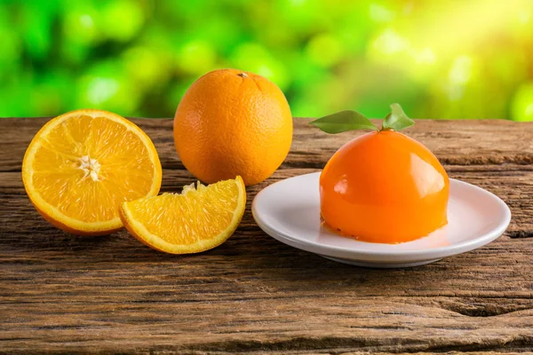 Orange cake on grunge wooden table — Stock Photo, Image