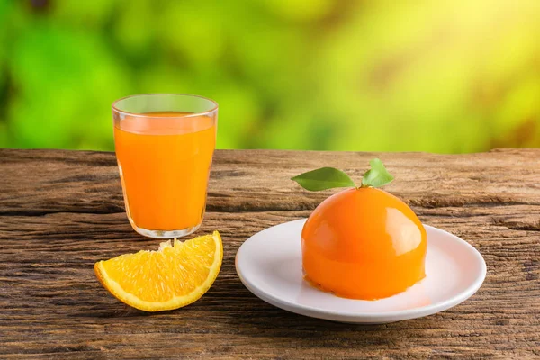 Orange cake and Glass of Fresh Orange Juice on grunge wooden tab
