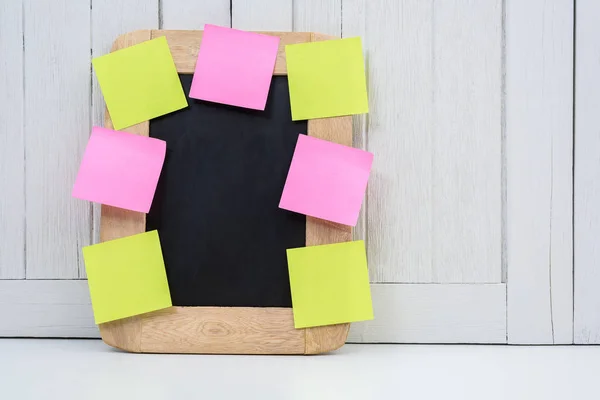 Chalkboard and blank sticky note, post note or post-it on Office