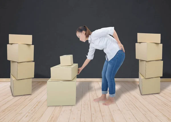 Mulher que sofre de dor nas costas enquanto se move caixas — Fotografia de Stock