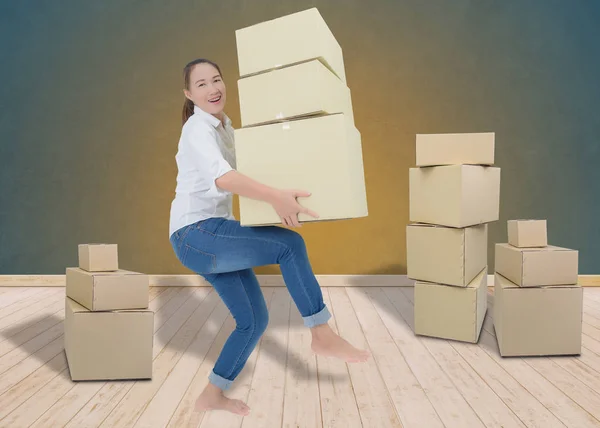 Woman carrying and lifting boxes — Stock Photo, Image