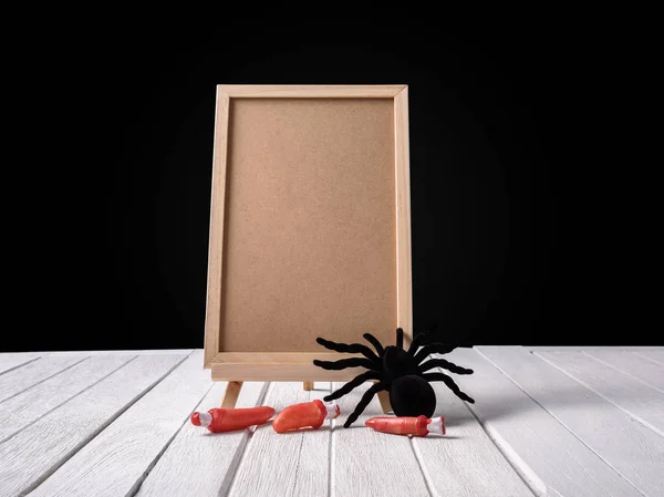 The chalkboard on the stand with Halloween Black spider and fing