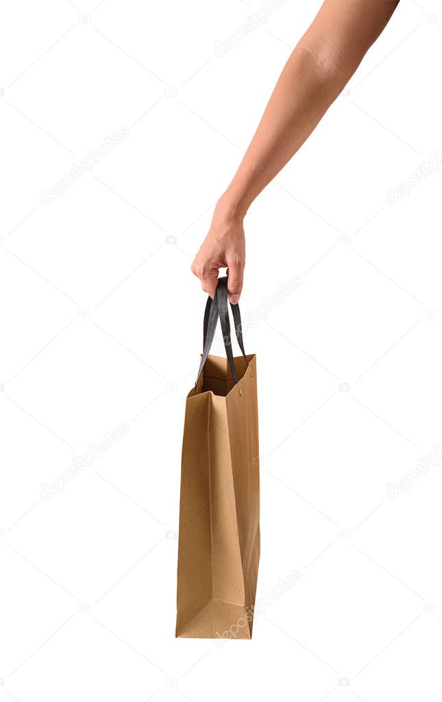 Female hand holding blank brown paper shopping bags