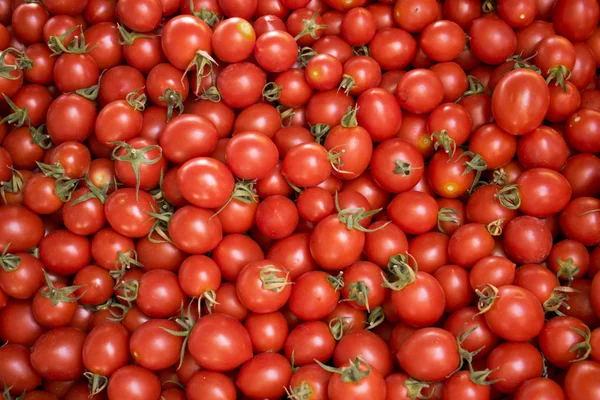 Fresh red tomatoes at a farmers market. Healthy food. Organic vegan background.