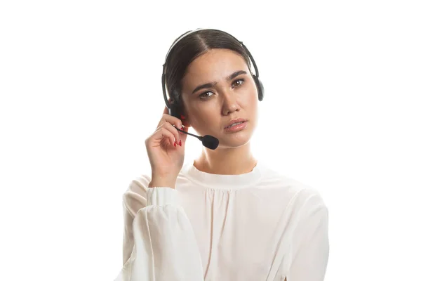 Beautiful consultant of call center in headphones on white background