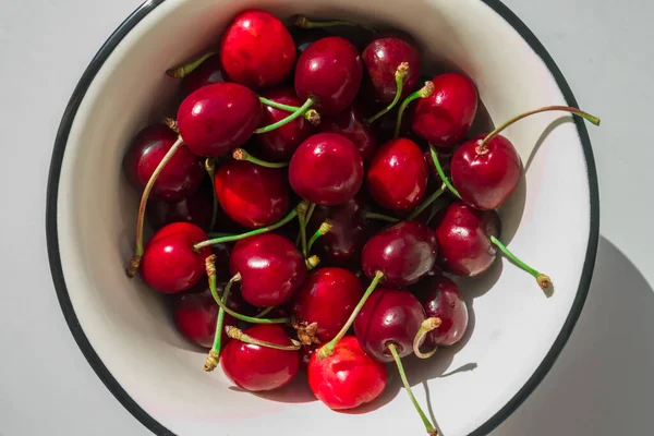 First red cherries of the year in the beginning of June, Summer. Round plate