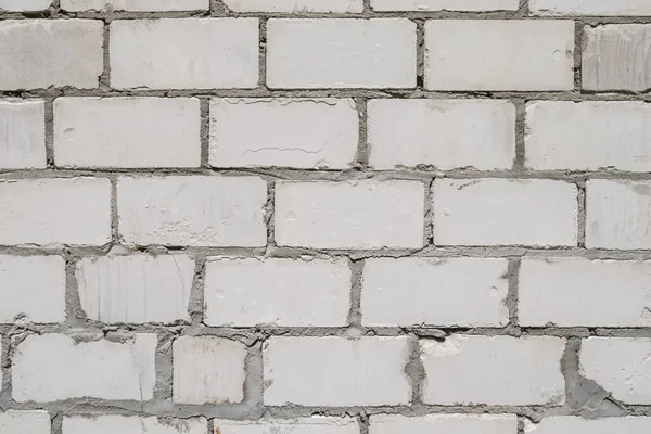 Old imperfect white grey brick wall with cracks. Background — Stock Photo, Image