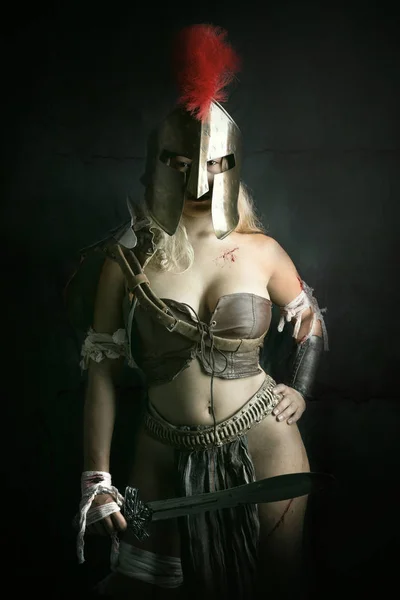 Ancient woman warrior or Gladiator posing in a dark background