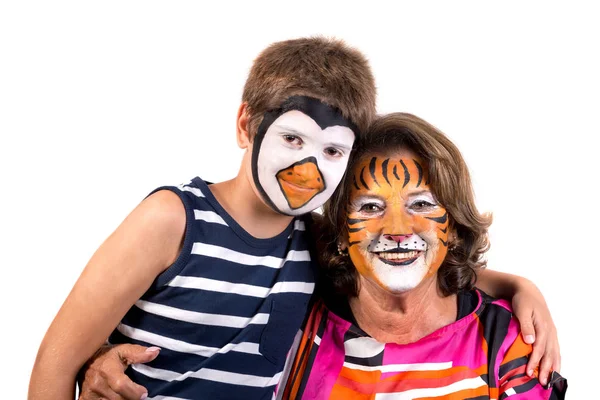 Kid a babička s barvy na obličej — Stock fotografie