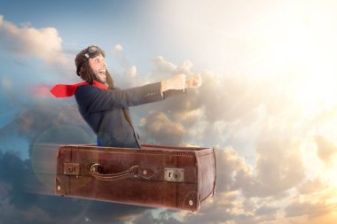 Businessman flying an old suitcase over the skies clipart