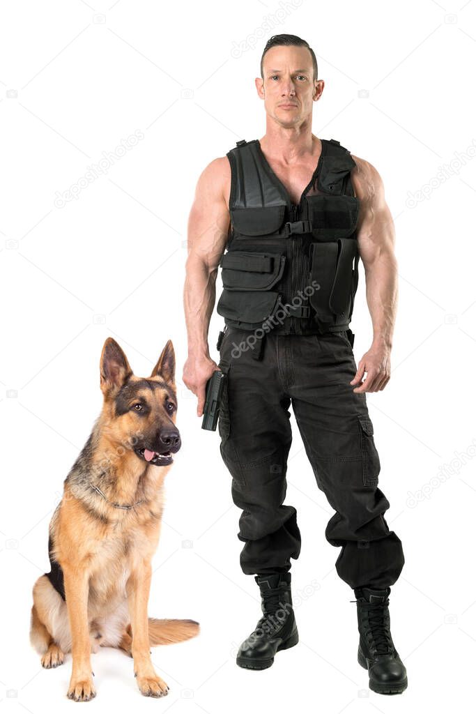 Police dog and agent with tactical vest and gun isolated in white