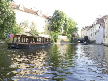 Prag, Çek Cumhuriyeti - 7 Mayıs 2018: Motorlu bir tekne Vltava Nehri boyunca yelken. Prag nehre kanalları boyunca bir turist tekne yelken. Turistler manzaraları (ilk kişi görünümünden tekneden izlemek).