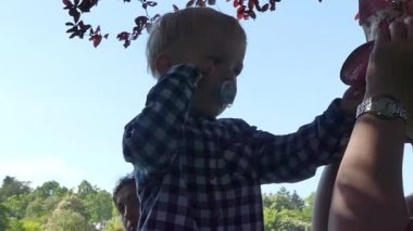 Prag, Çek Cumhuriyeti - 7 Mayıs 2018: Anne ve oğlu kameraya gülümsüyorsun. Bir kızın kollarında iki yaşında bir çocuk.