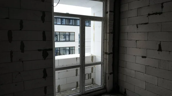 Construction of an apartment high-rise building of aerated concrete. View of the built apartment inside the newly-built high-rise building. Empty walls of new buildings from the gas block.