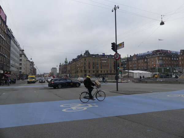 COPENHAGEN, DENMARK - MARCH 2019: Tourists walk along a city str