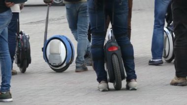 Kişisel elektrikli taşıma, tek tekerlekli. Yakın çekim, tek tekerlekli birçok bacak. Elektrikli ulaşım severlerin koleksiyonu.