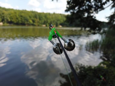 Orman gölünde balıkçılık. Balıkçılık sırasında Spinning üzerinde çan.