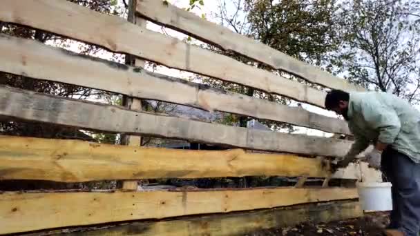 Bearded Man Paints New Wooden Fence Processing New Wooden Fence — Stock Video