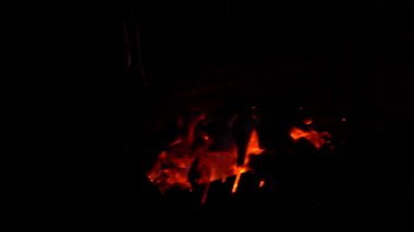 Sparks from a fire scatter on a black background. Sparks from a barbecue in the dark.