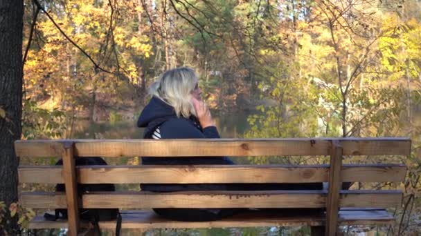 Chica Sentada Banco Utiliza Teléfono Inteligente Fondo Del Lago Bosque — Vídeo de stock