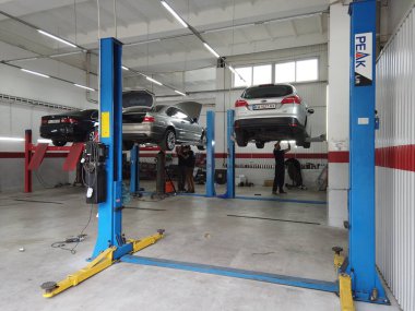 Avrupa, Kiev, Ukrayna - Temmuz 2020: Teknik bir denetim istasyonundaki otomobil egzoz sisteminin tamiri. Araba tamircisi araba tamiri yapar, kaynak yapar..