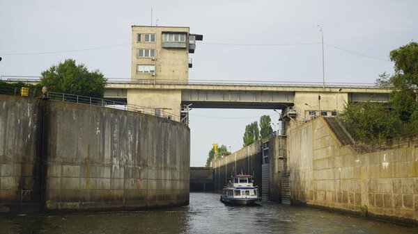 Vyshgorod, Kiev region, Ukraine - September 2020: A pleasure motor ship passes the locks of the Kiev reservoir. The motor ship passes the gateway of the Kiev sea.