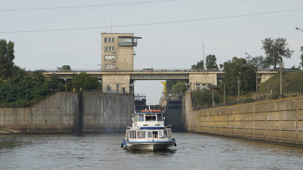 Vyshgorod, Kiev region, Ukraine - September 2020: A pleasure motor ship passes the locks of the Kiev reservoir. The motor ship passes the gateway of the Kiev sea.